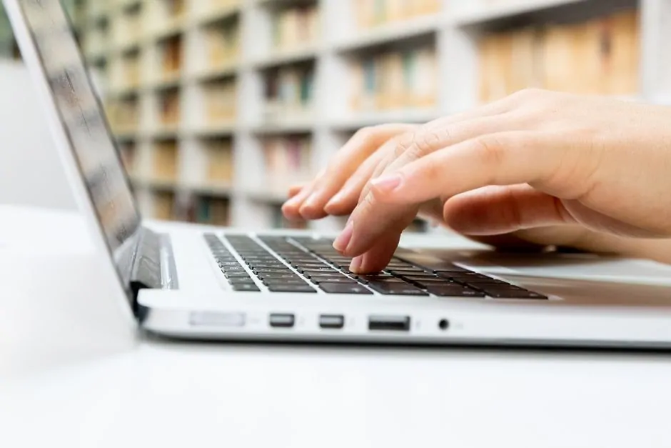 Entrepreneur typing on a laptop to check whether a domain name is still available