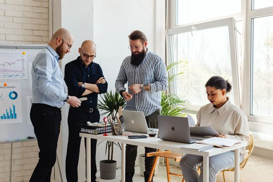 Two colleagues working together on a laptop in an office